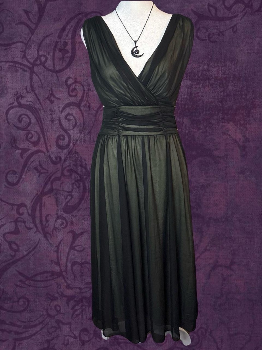 Black maxi dress with green underneath with a flowy bottom